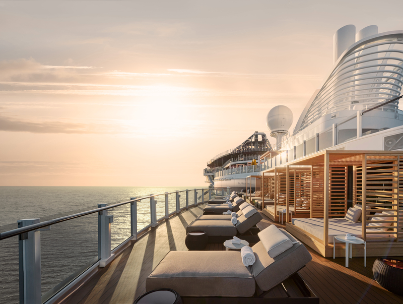 Private luxury sundeck on a premium cruise ship with lounge chairs overlooking the ocean